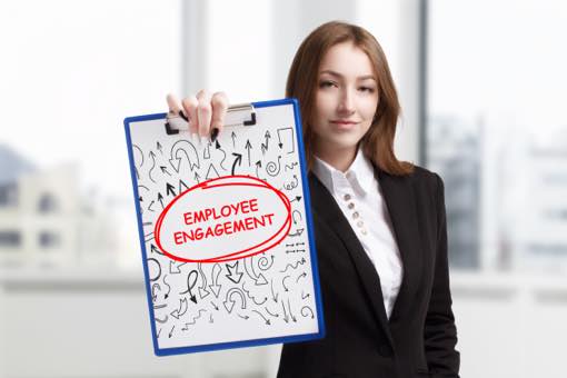 young-business-women-in-suit-holding-sign-that-says-employee-engagement-circled-in-red